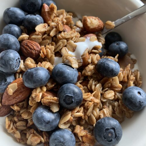 granola and yogurt topped with blueberries